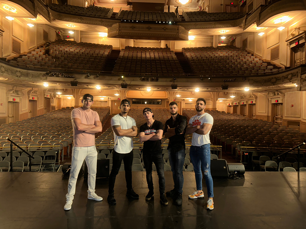 Leon Budrow and performers inside a large theatre